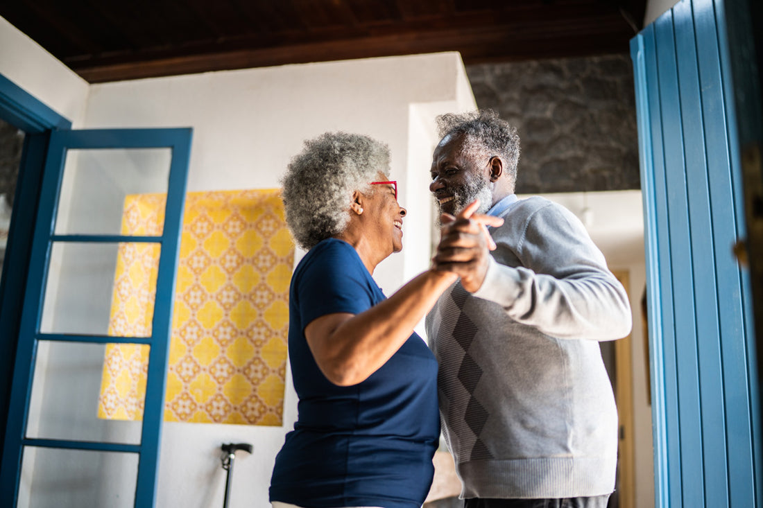 Mature couple dance joyfully to keep active