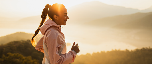 Young woman, running at sunrise