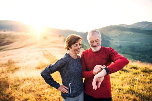  Happy senior woman leading her family to a perfect picnic place on the hill. 