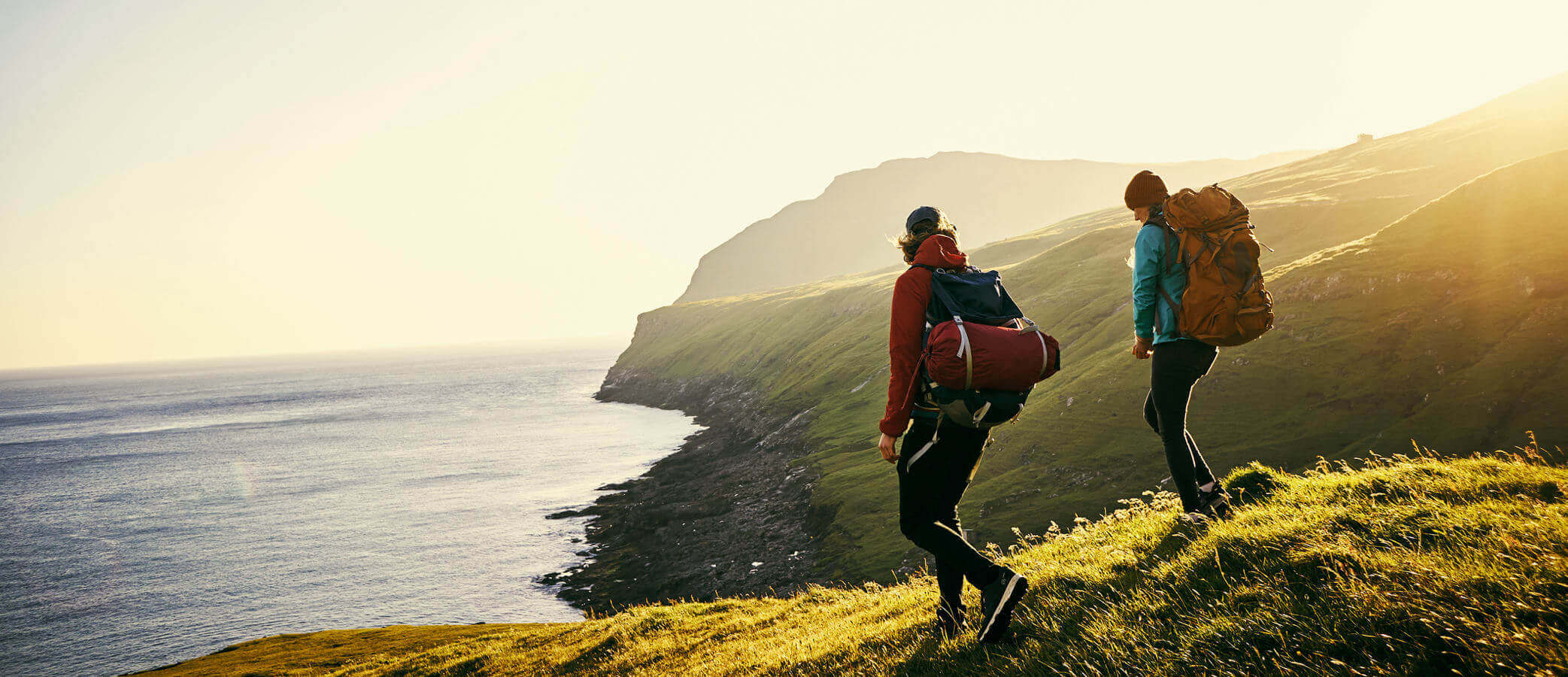 Young couple hiking along the ridge of an ocean coastline